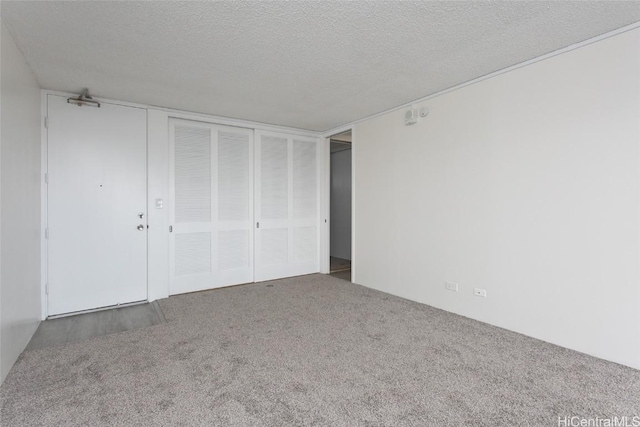 unfurnished bedroom featuring carpet, a closet, and a textured ceiling