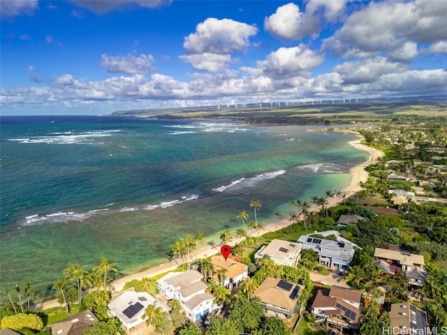 drone / aerial view featuring a beach view and a water view