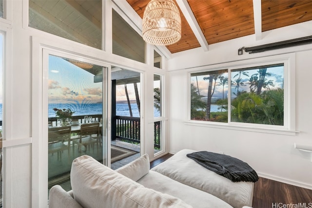 bedroom with access to outside, multiple windows, a water view, and lofted ceiling with beams