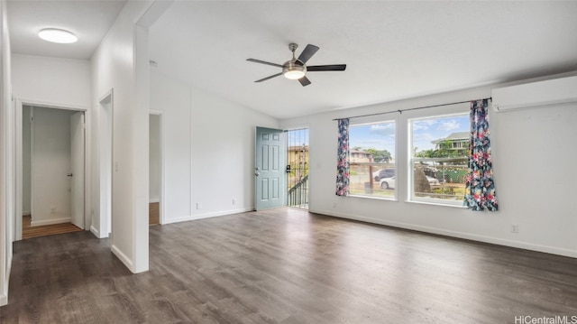 empty room with a wall mounted AC, ceiling fan, and dark wood-type flooring