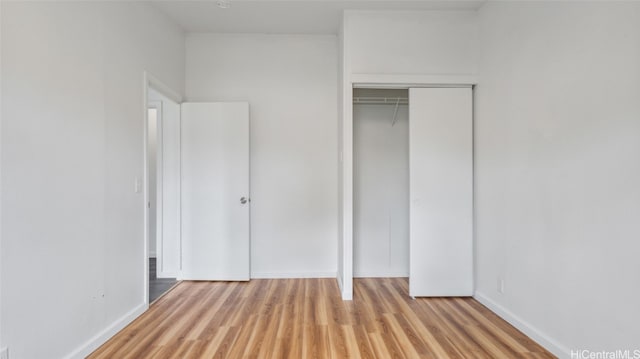 unfurnished bedroom with light hardwood / wood-style floors and a closet