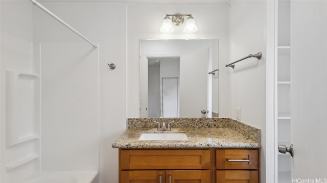 bathroom with a shower and vanity