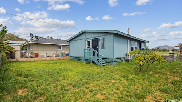 back of house featuring a yard