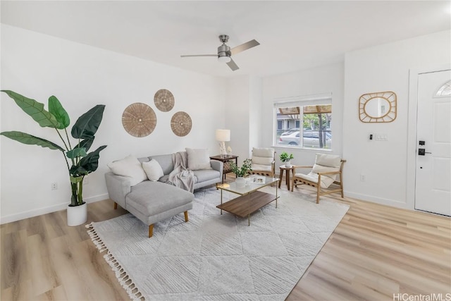 living room featuring light hardwood / wood-style floors and ceiling fan