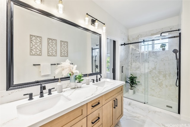 bathroom with vanity, a shower with door, and a wealth of natural light