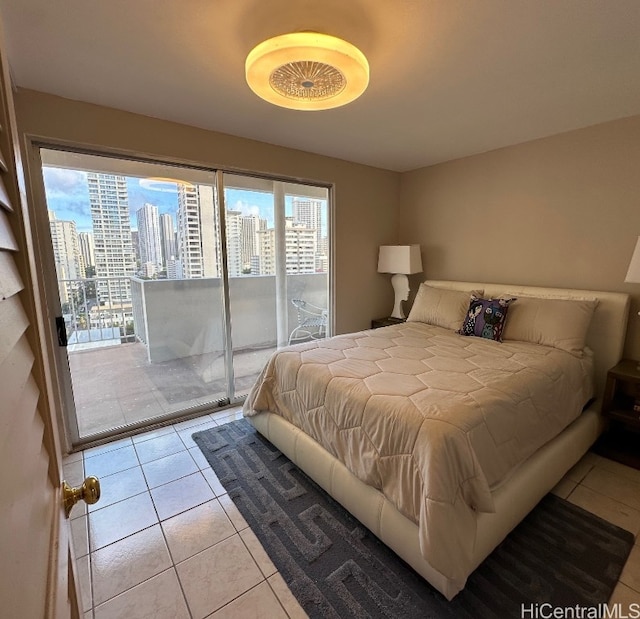 bedroom featuring access to outside, multiple windows, and light tile patterned flooring