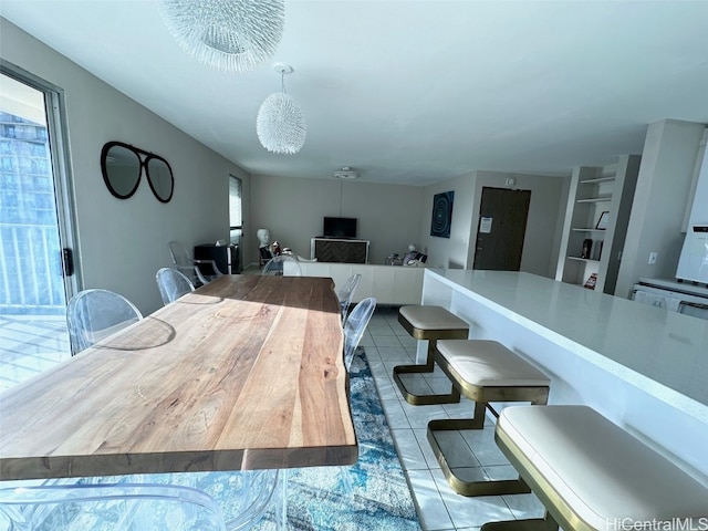 tiled dining area featuring a notable chandelier