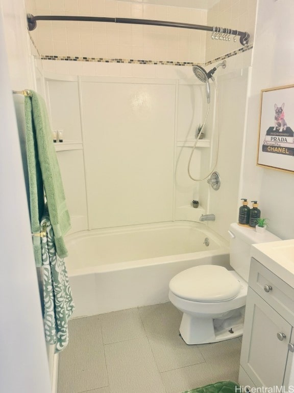 full bathroom featuring tile patterned flooring, vanity, toilet, and tiled shower / bath