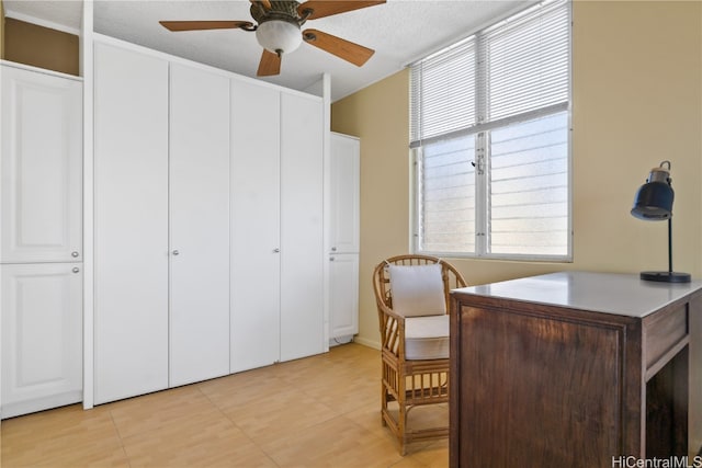 office area featuring a textured ceiling and ceiling fan