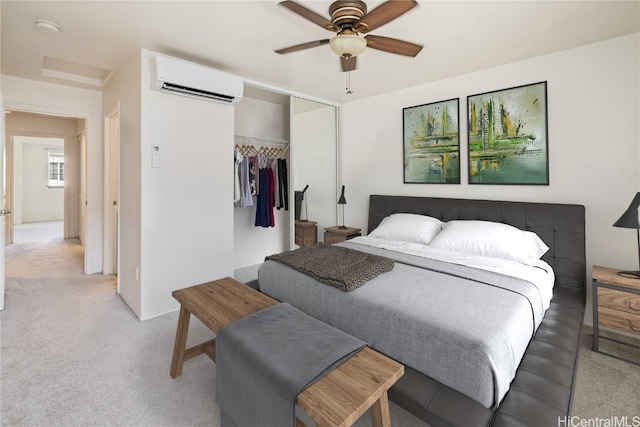 carpeted bedroom with ceiling fan, an AC wall unit, and a closet