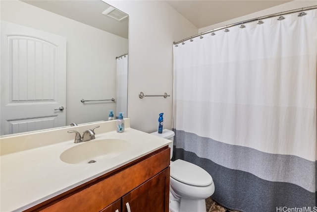 bathroom featuring vanity and toilet