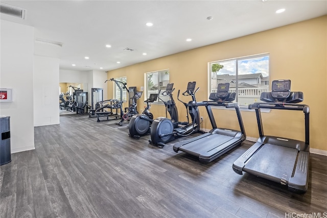 exercise room with dark wood-type flooring