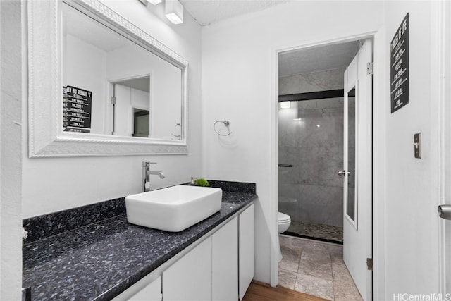 bathroom featuring vanity, toilet, and an enclosed shower