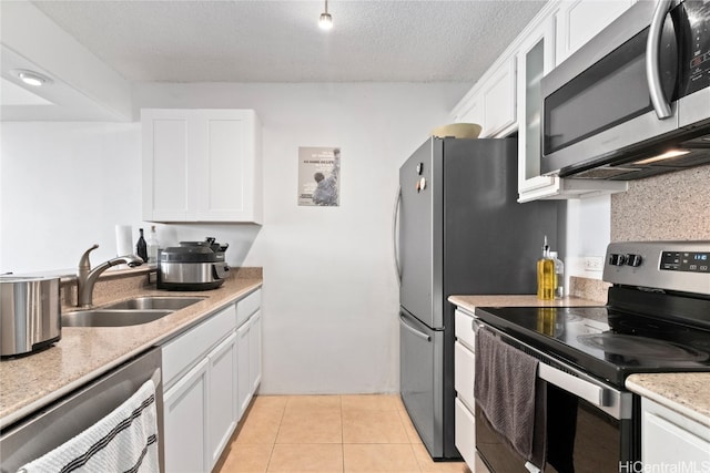 kitchen featuring white cabinetry, appliances with stainless steel finishes, a textured ceiling, and sink