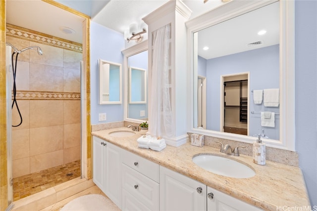 bathroom featuring vanity and a tile shower