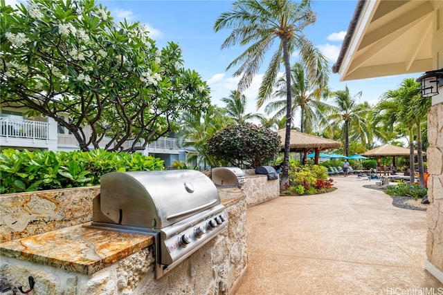 view of patio / terrace with a grill, a gazebo, and exterior kitchen