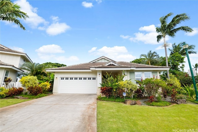 view of front of home featuring a garage and a front yard