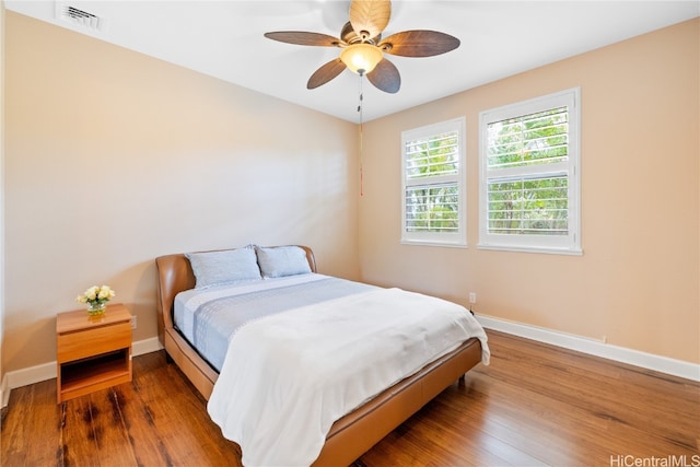 bedroom with ceiling fan and wood-type flooring