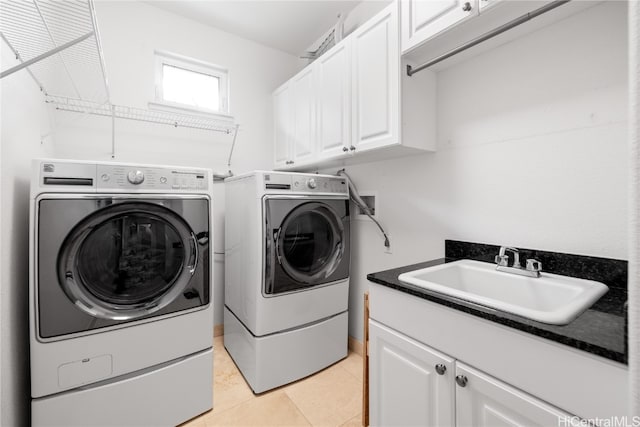 laundry room featuring cabinets, separate washer and dryer, sink, and light tile patterned flooring