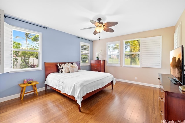 bedroom with light hardwood / wood-style floors and ceiling fan