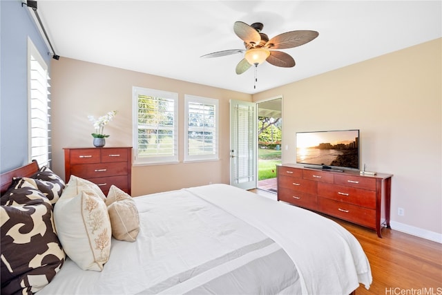 bedroom featuring ceiling fan, access to exterior, and light hardwood / wood-style flooring