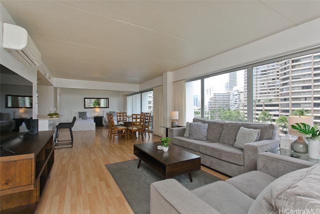 living room with light wood-type flooring and a wall unit AC