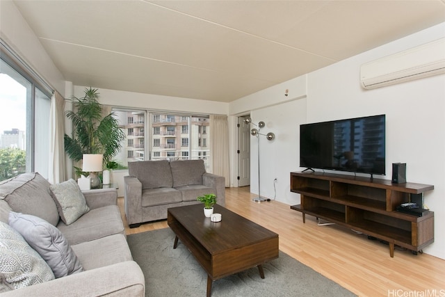 living room featuring an AC wall unit and hardwood / wood-style flooring