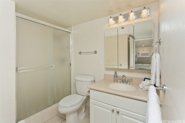 bathroom with tile patterned flooring, vanity, toilet, and a shower with door