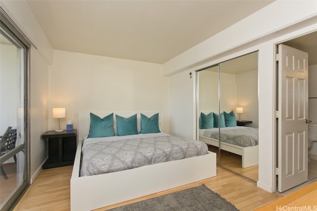 bedroom with wood-type flooring and a closet