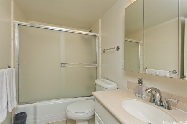 full bathroom with tile patterned floors, toilet, combined bath / shower with glass door, and vanity