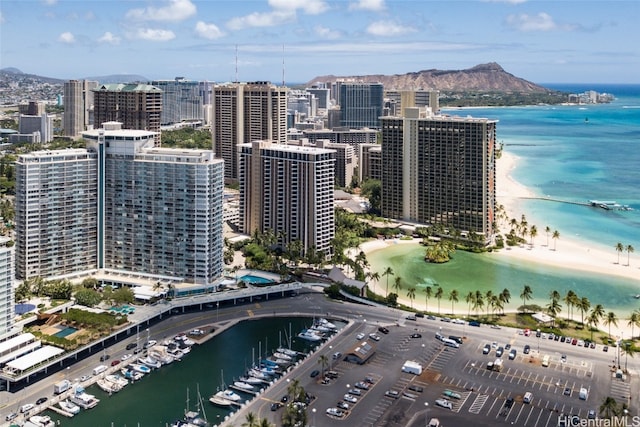 aerial view featuring a water and mountain view and a beach view