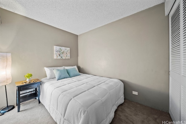 carpeted bedroom with a textured ceiling