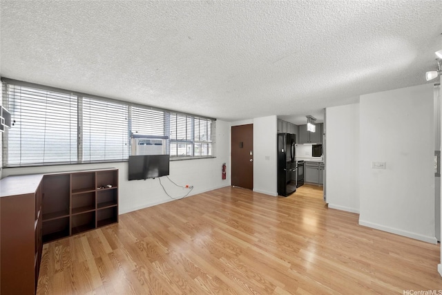 502 Captain Cook Ave Unit 303, Honolulu, HI 96813 - unfurnished living room featuring a textured ceiling, light wood-style floors, and cooling unit