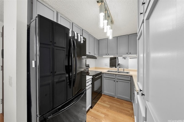 502 Captain Cook Ave Unit 303, Honolulu, HI 96813 - kitchen featuring black appliances, gray cabinets, light wood-type flooring, a textured ceiling, and light countertops