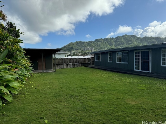 view of yard with a mountain view and a shed