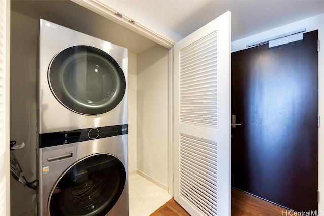 washroom featuring stacked washer / dryer