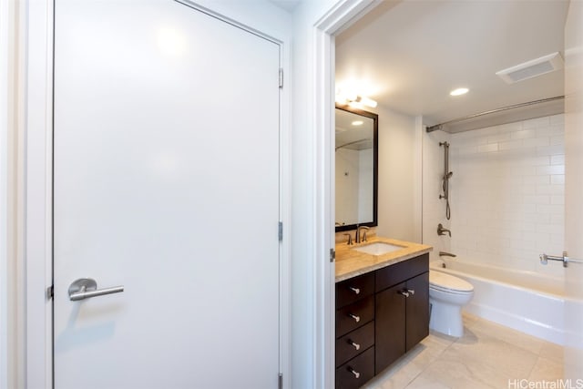 full bathroom with vanity, tiled shower / bath combo, tile patterned floors, and toilet