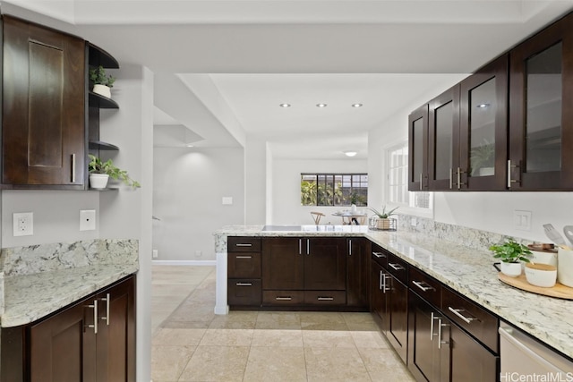 kitchen featuring light stone countertops, kitchen peninsula, dark brown cabinets, and stainless steel dishwasher