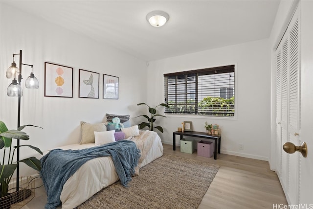 bedroom with a closet and light wood-type flooring