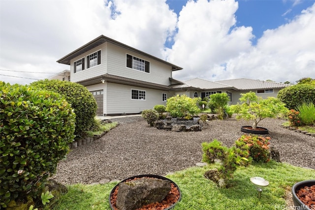 back of property with a garage