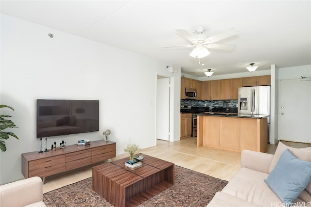 living room with ceiling fan and light hardwood / wood-style floors