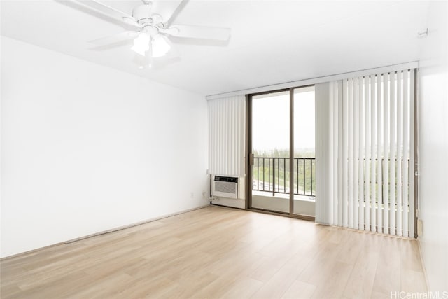 spare room with ceiling fan, a healthy amount of sunlight, and light hardwood / wood-style flooring