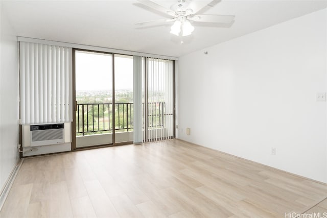 unfurnished room featuring cooling unit, floor to ceiling windows, ceiling fan, and light hardwood / wood-style flooring