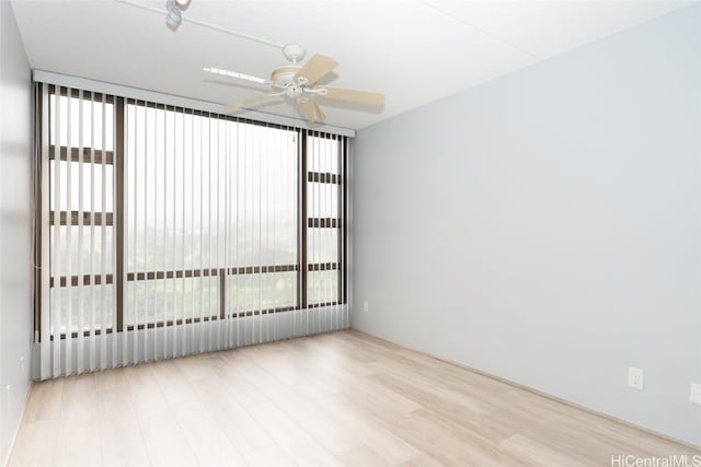 empty room featuring ceiling fan and light wood-type flooring