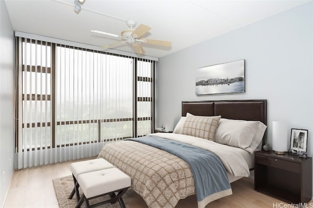 bedroom with light wood-type flooring, ceiling fan, and access to exterior