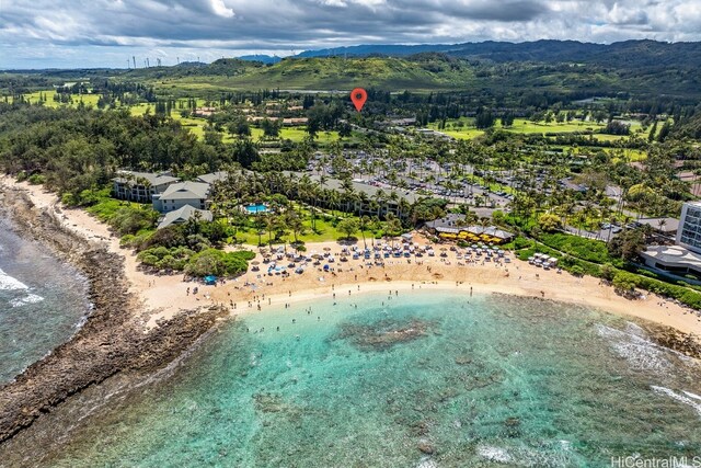 birds eye view of property with a view of the beach and a water and mountain view