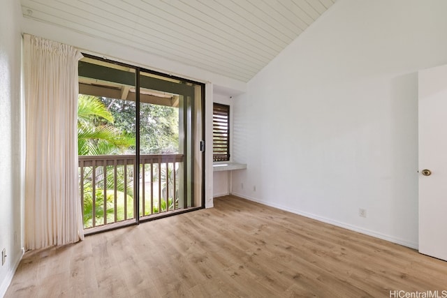 spare room with high vaulted ceiling, light wood-type flooring, and wood ceiling