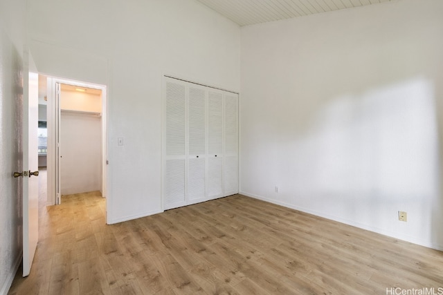 unfurnished bedroom with light hardwood / wood-style floors and a closet