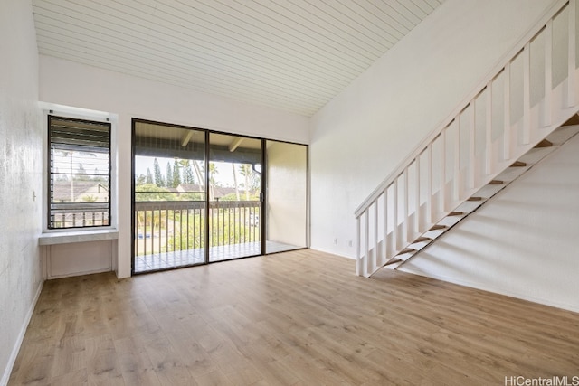 spare room with lofted ceiling, light hardwood / wood-style floors, plenty of natural light, and wooden ceiling