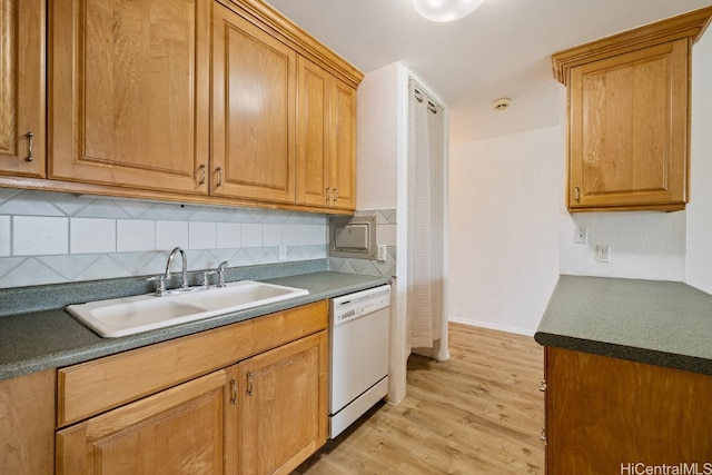 kitchen featuring backsplash, dishwasher, light hardwood / wood-style floors, and sink